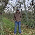 man standing in orchard