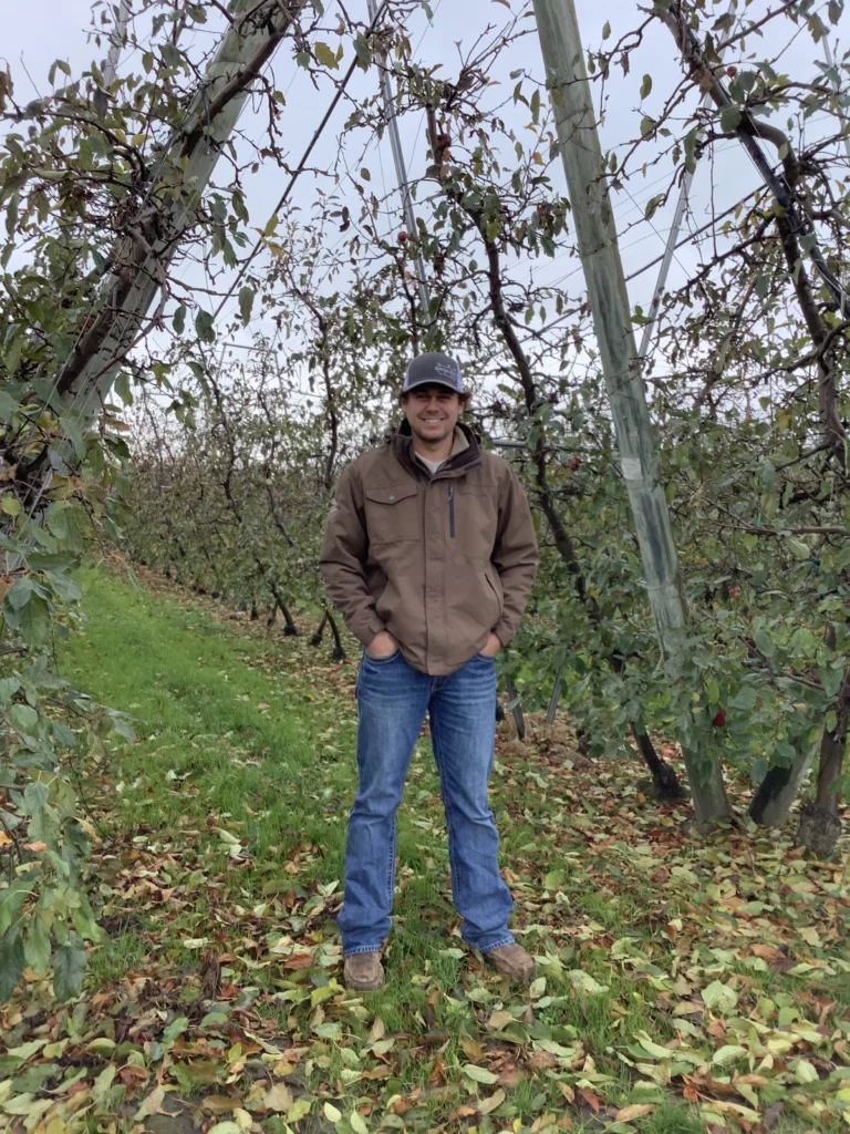 man standing in orchard